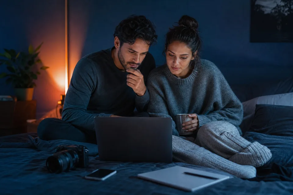 Creator couple planning their content calendar on a laptop